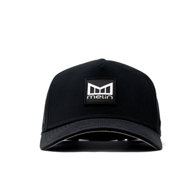 Close-up of Hydro Odyssey Stacked Black Camo Hat showing Black cap with woven logo patch featuring geometric shield and text
