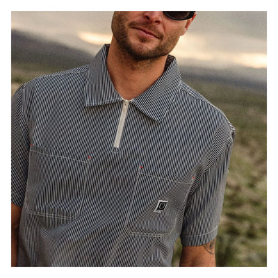 Person wearing Journey LW SS Woven Navy/white Stripe S/S Woven S/S Woven, Desert landscape with rolling hills and overcast