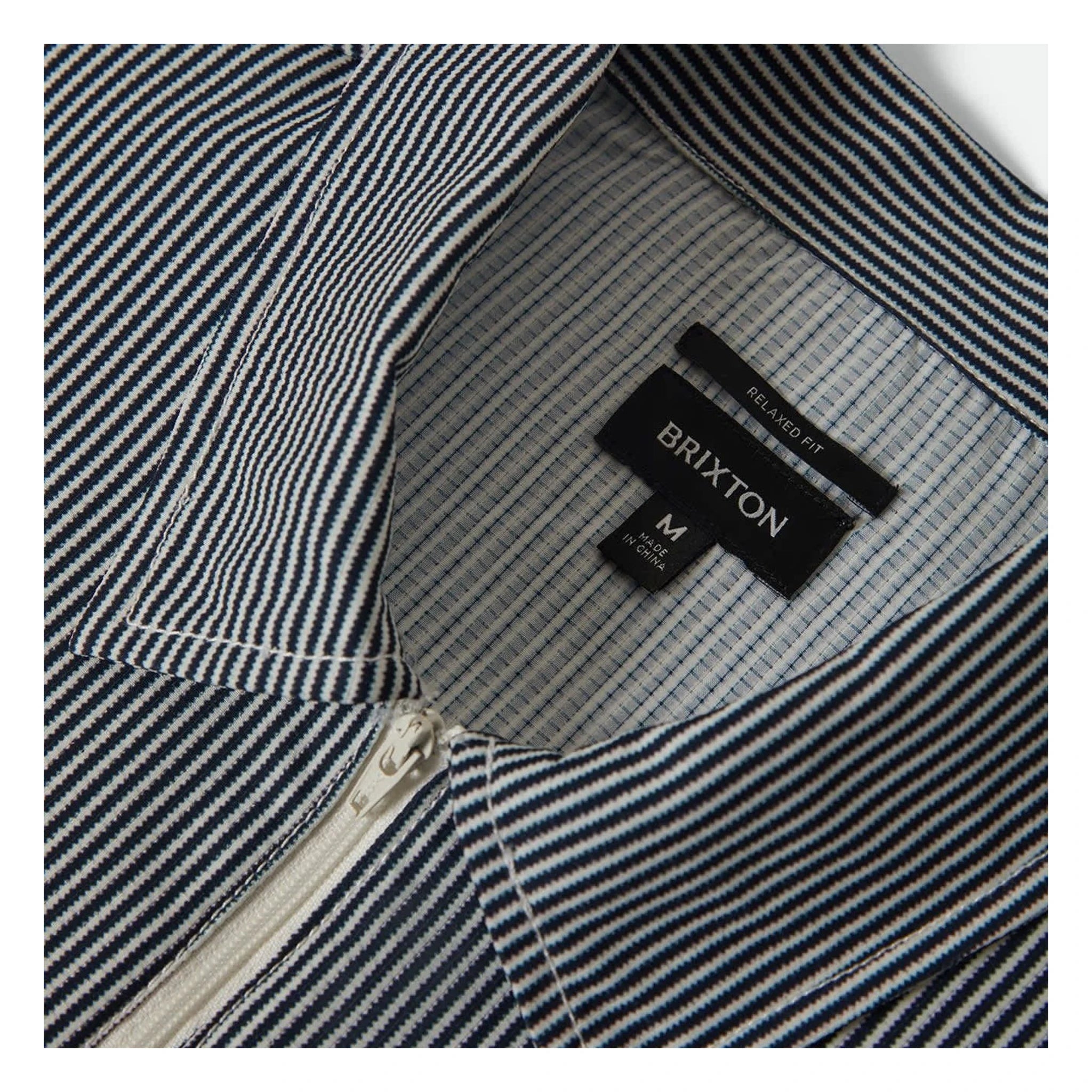 Care label on Journey LW SS Woven Navy/white Stripe S/S Woven S/S Woven showing Black label with white text reading