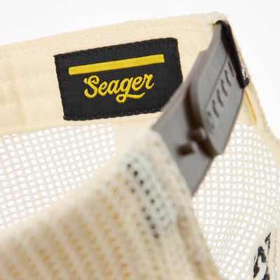 Care label on Keep It Country Trucker Apparel Brown/Cream Apparel showing Black woven label with yellow script text and