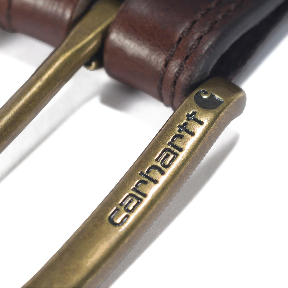 Close-up of Leather Engraved Buckle Belt Accessory Brown Accessory showing Brass buckle with embossed text and dark leather