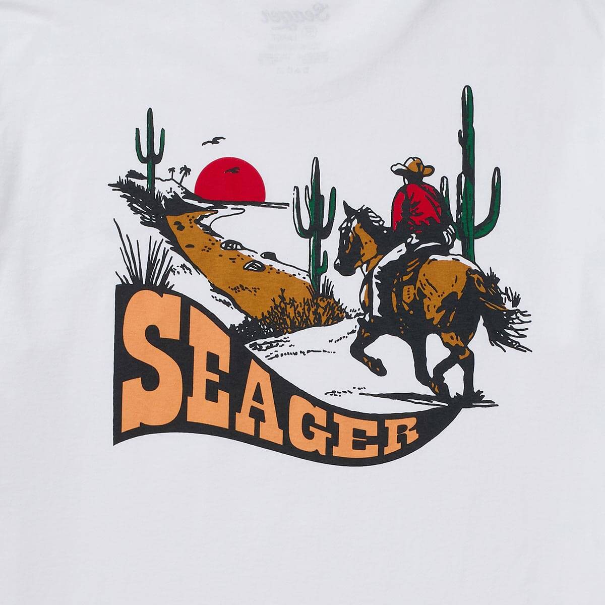 Close-up of Long Ride White Tee showing Print texture showing hand-drawn linework with solid color fills in desert scene -