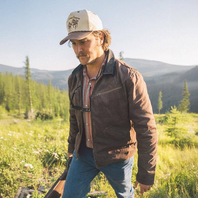 Person wearing Los Rios Canvas Snapback Cream/black Hat, Mountain valley with coniferous forest under clear sky - Slowride