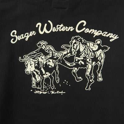 Close-up of Los Rios Black Hoodie showing Cream outline print of cowboy on bucking horse with text "Seager Western Company"