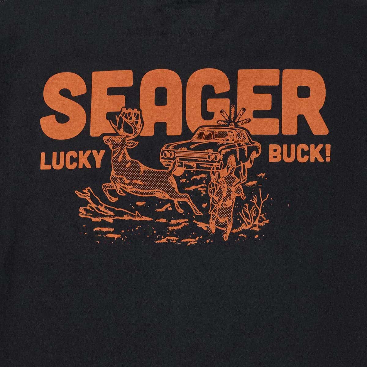 Close-up of Lucky Buck Black Tee showing Orange halftone print showing deer leaping over vintage sedan with dust clouds and