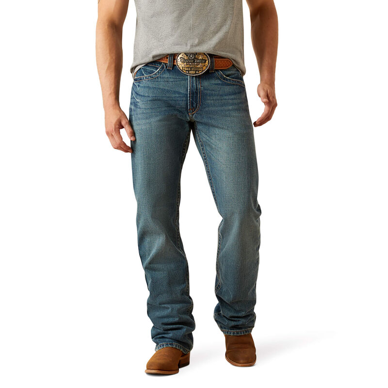 M4 M Series Bootcut Scoundrel Pants front view, Medium blue bootcut denim with brown leather belt and brass circular buckle,