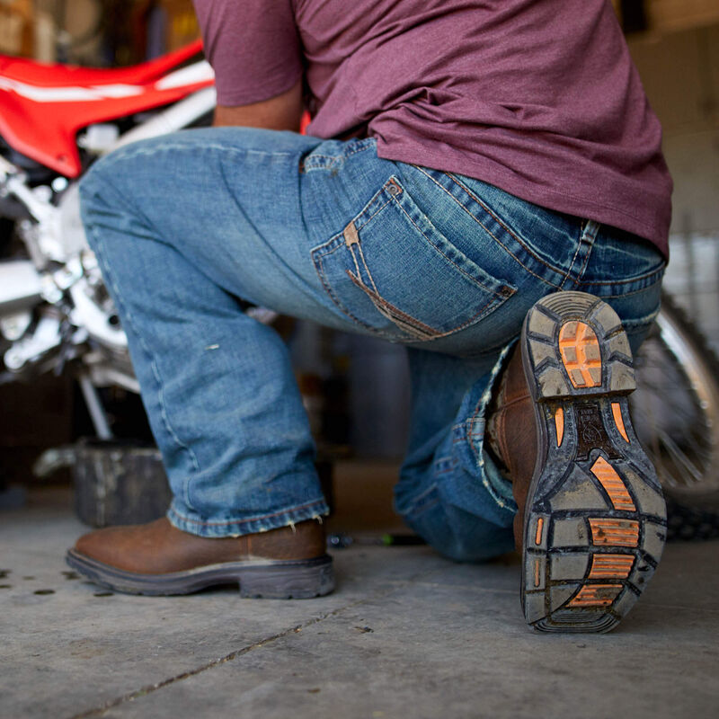 Person wearing M4 M Series Bootcut Scoundrel Pants Pants, Garage setting with vintage motorcycle in background - Slowride