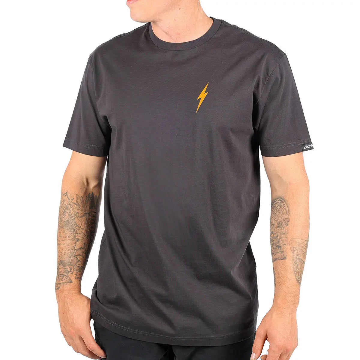 Person wearing Manasa Graphite Black Tee, Man wearing graphite black tee with gold lightning bolt, studio setting with white