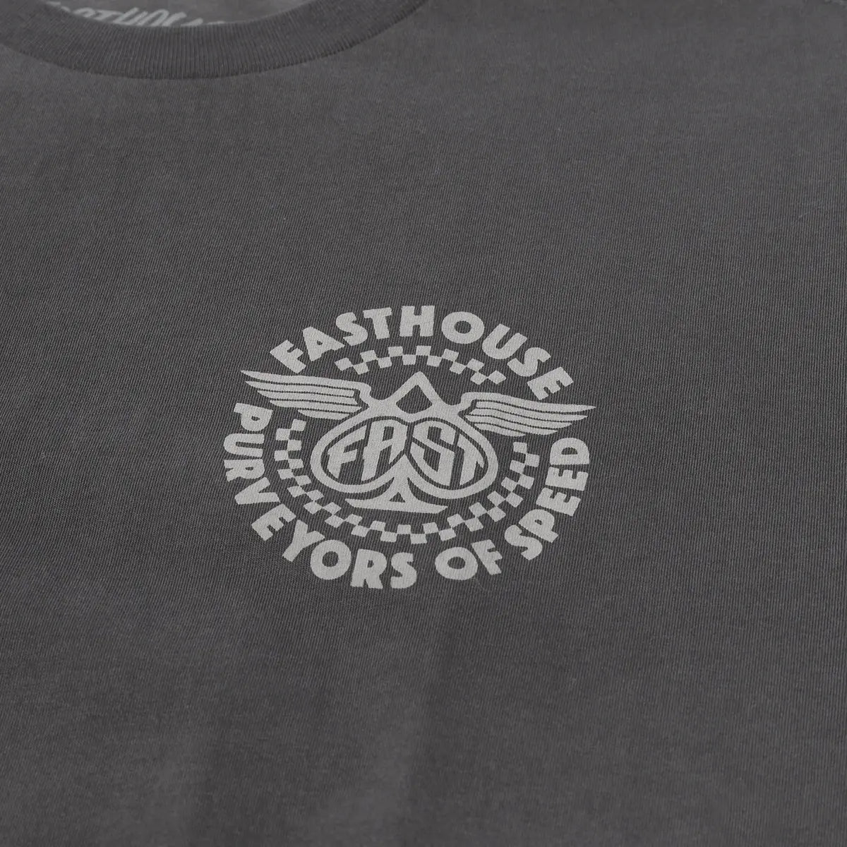 Close-up of Maverick Graphite Black Tee showing Cream embroidered graphic featuring wings, checkered borders, and circular