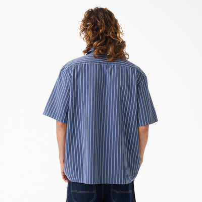 Person wearing Mens Worn in Lightweight Work Shirt S/S Woven Black S/S Woven, Neutral studio setting with white background -