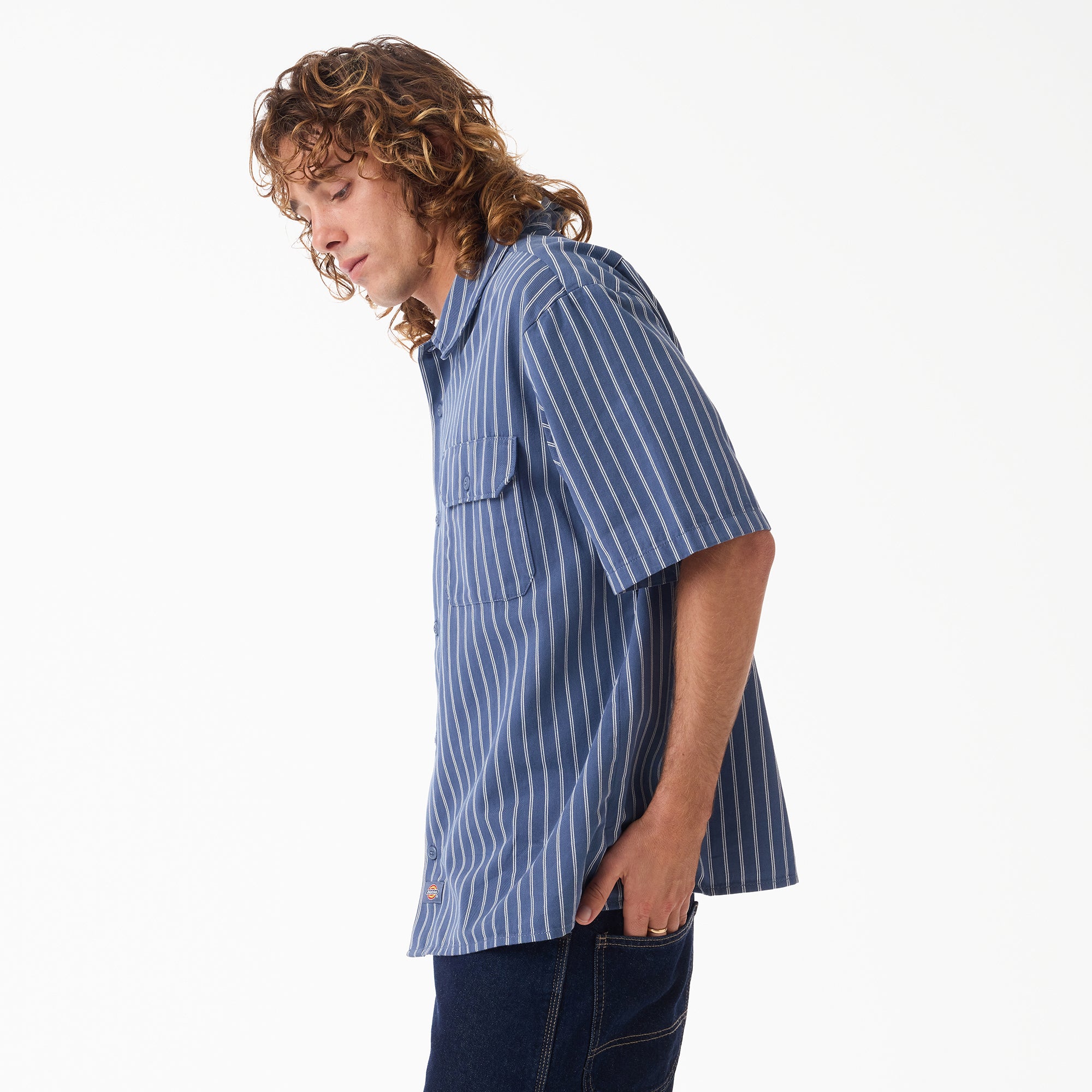 Person wearing Mens Worn in Lightweight Work Shirt S/S Woven Black S/S Woven, White studio background with neutral setting -