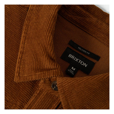 Care label on New West Relaxed Overshirt Washed Copper Cord Jacket showing Black woven label with "RELAXED FIT" above
