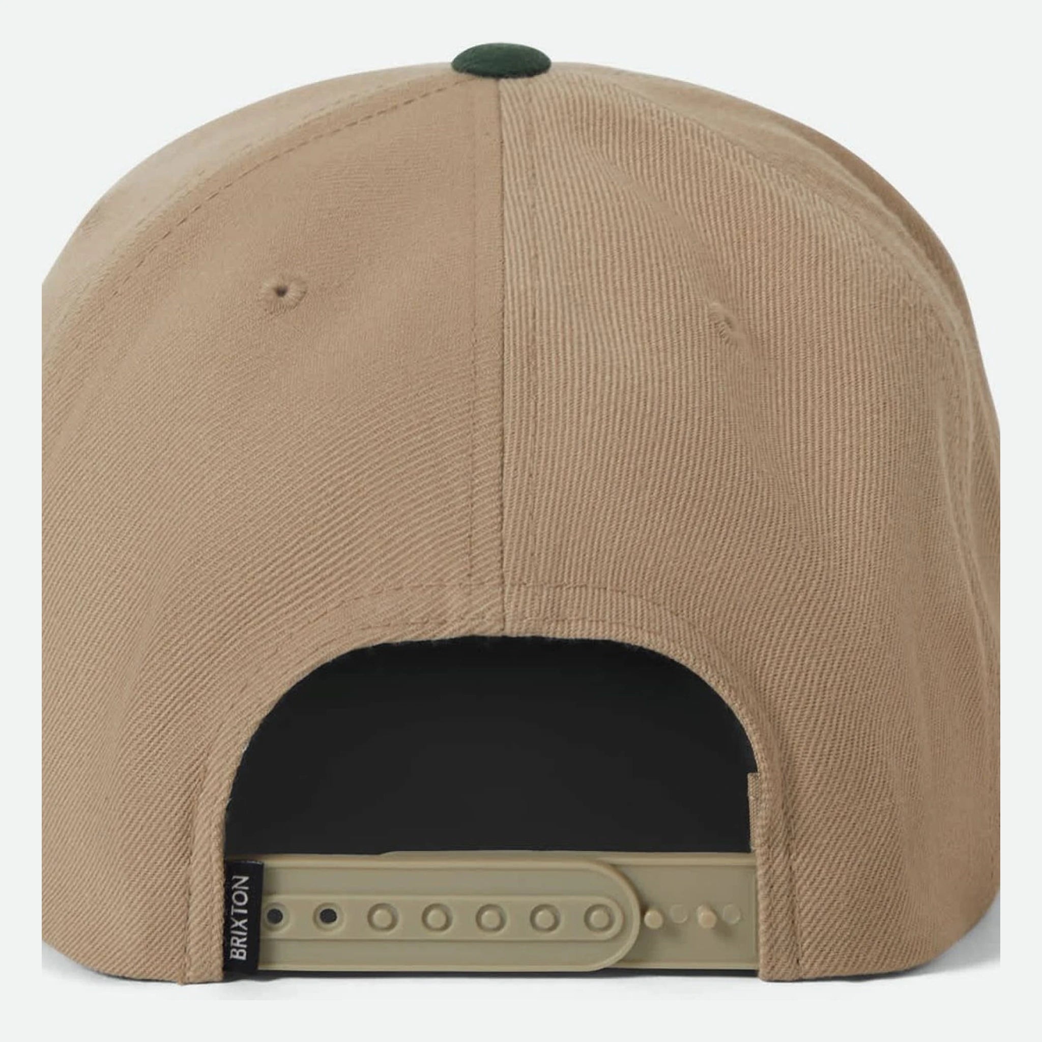 Close-up of Oath III Snapback Khaki/primal Green Hat showing Tan cotton twill crown with forest green button detail and