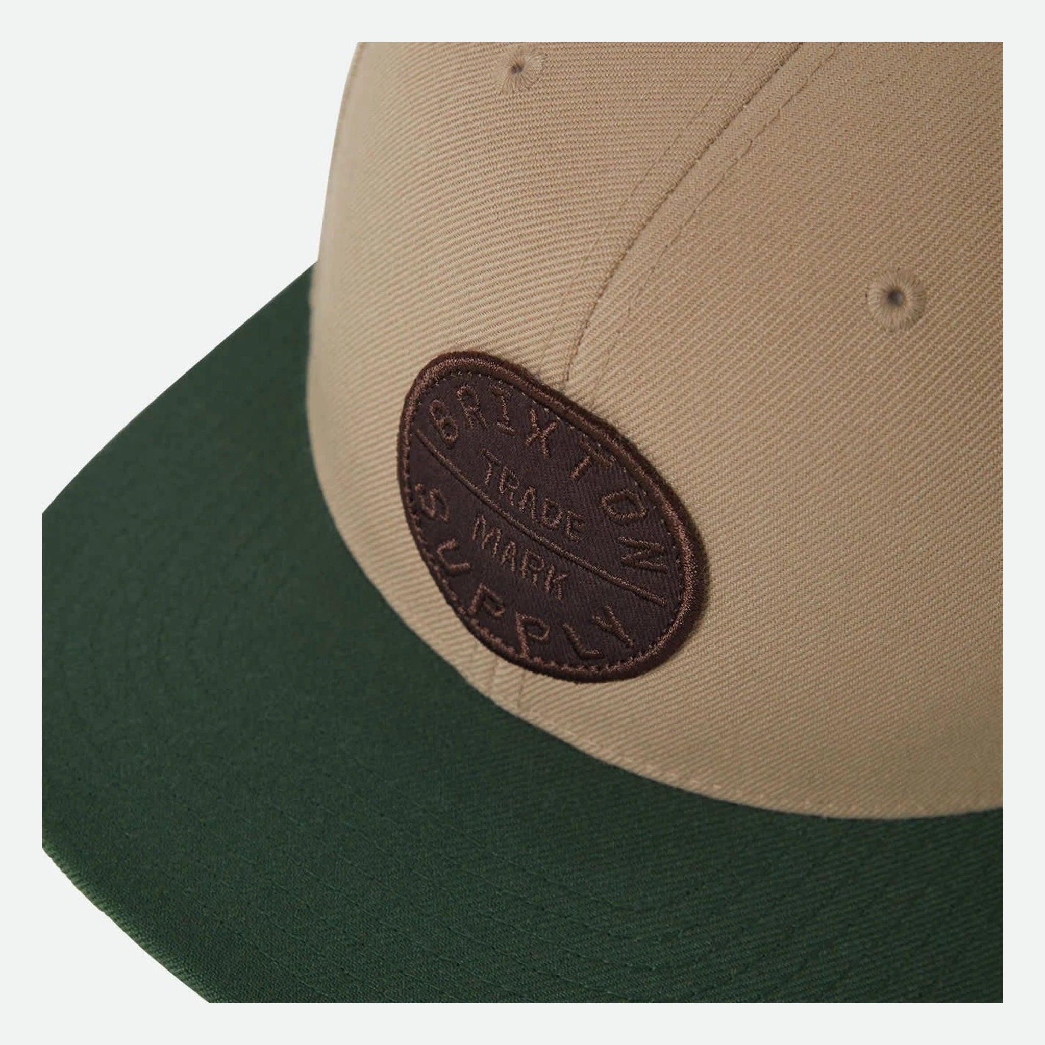 Close-up of Oath III Snapback Khaki/primal Green Hat showing Embroidered oval patch with brown thread on khaki panels, text
