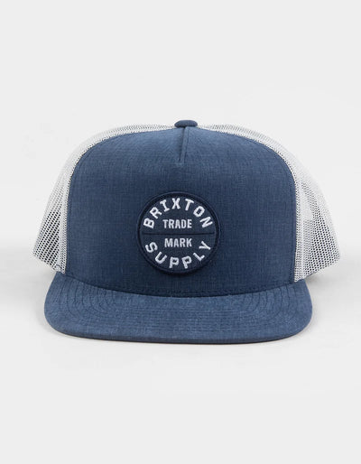 Oath MP Trucker Hat Apparel front view, Blue chambray front and bill with white mesh trucker panels, circular embroidered