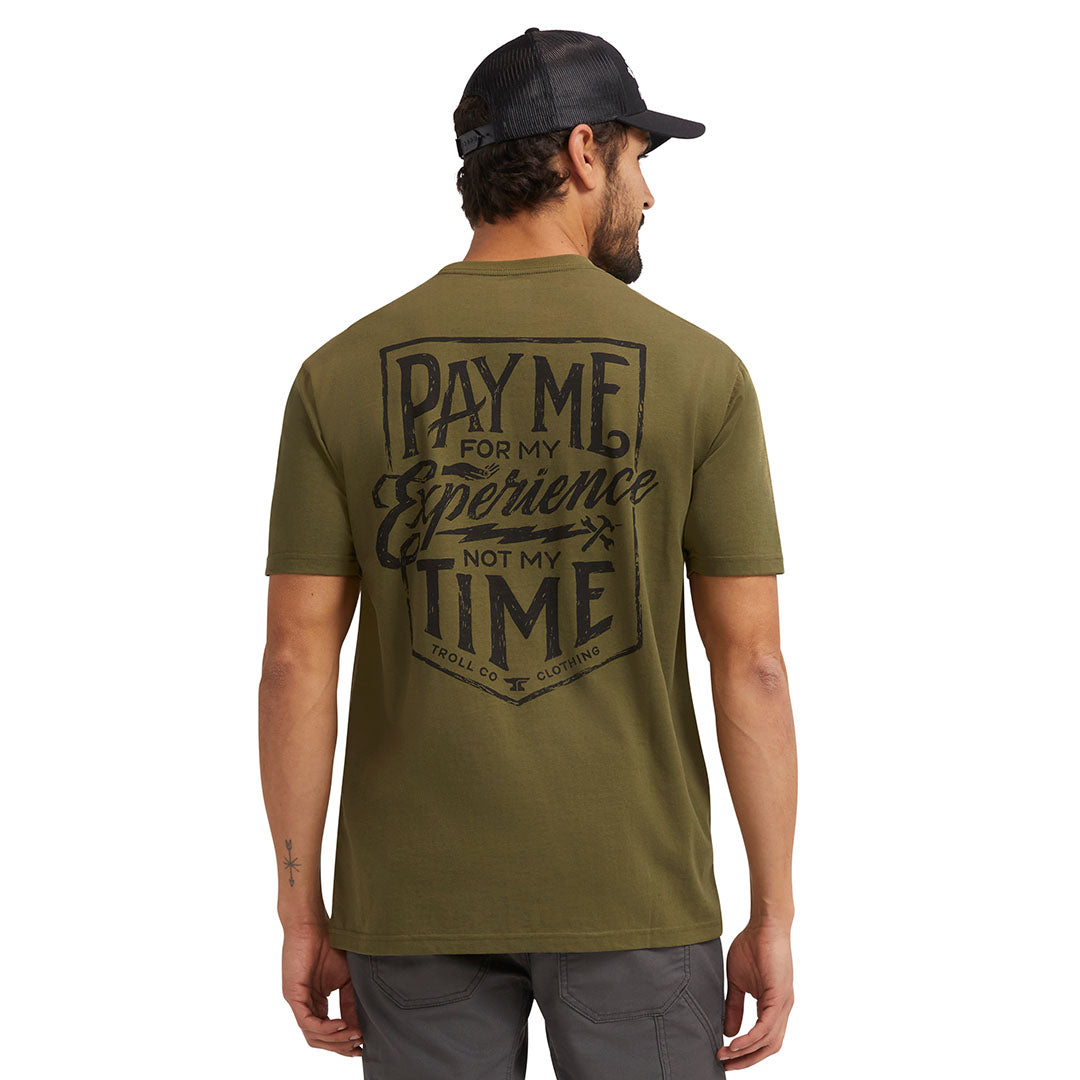 Person wearing Pay Me Military Tee, Man wearing military green tee against white studio background - Slowride Supply