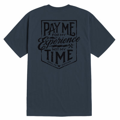 Close-up of Pay Me Military Tee showing Dark slate tee with centered back graphic in black ink featuring shield-shaped badge