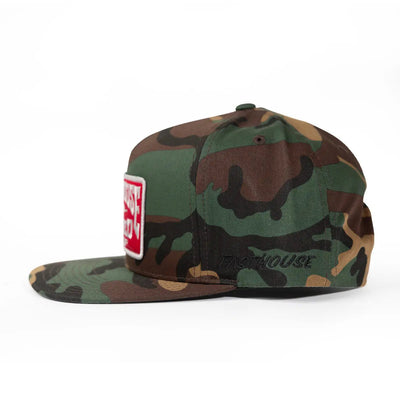 Close-up of Record Hat Apparel Black Apparel showing Woodland camouflage snapback with red and white rectangular patch on