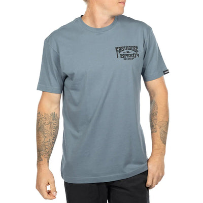 Person wearing Record Natural Tee, Man wearing slate blue tee standing against white studio backdrop - Slowride Supply
