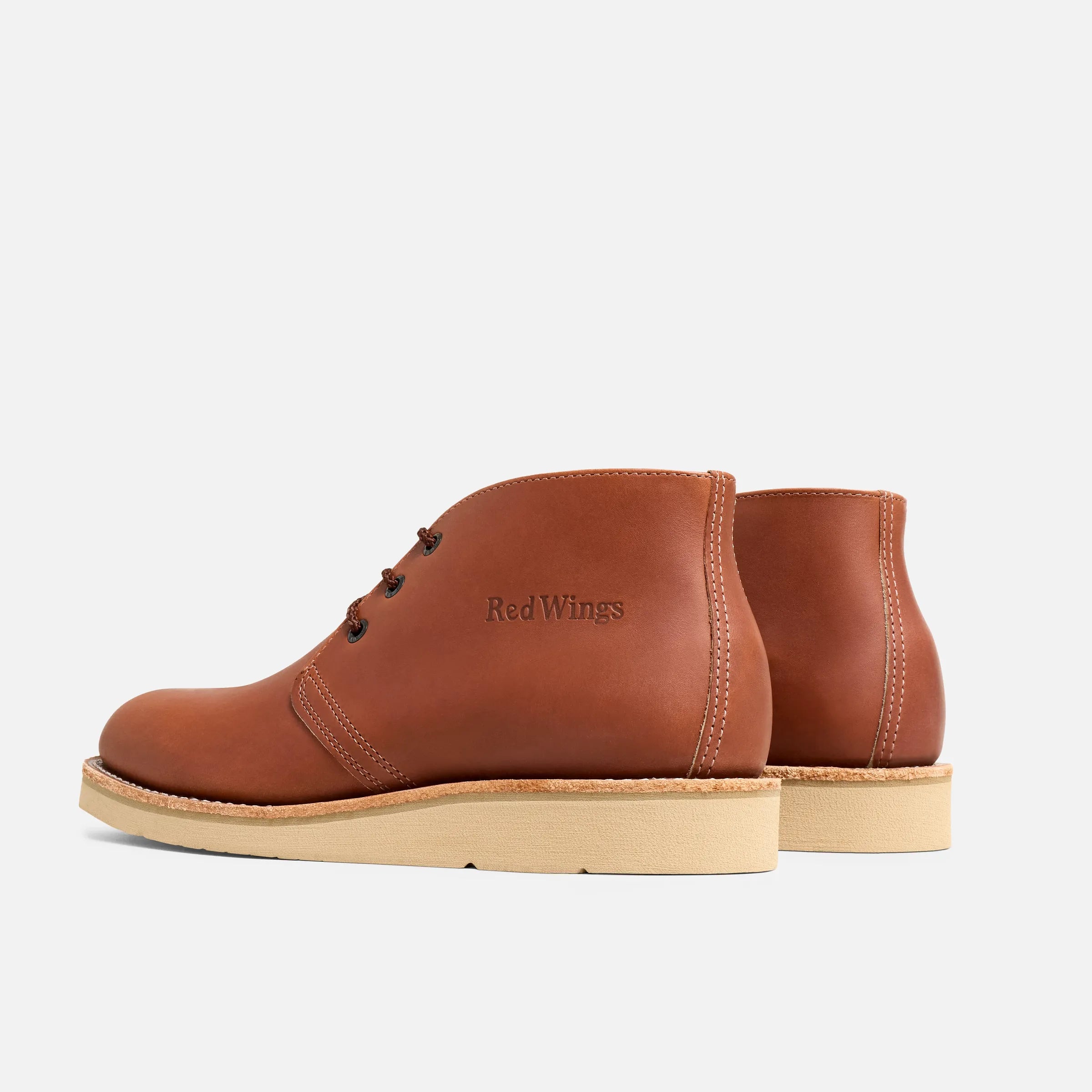 Close-up of 595- Traction Tred Chukka Boots Boots showing Tan crepe sole with contrast stitching and embossed branding on