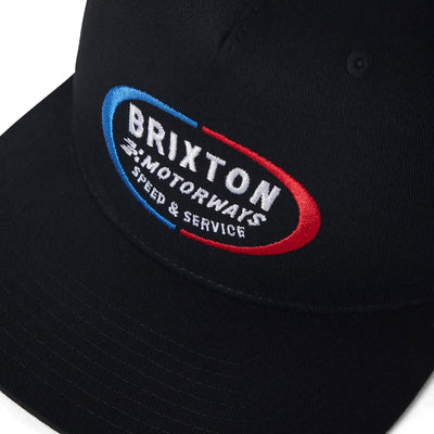 Close-up of Rhett MP Snapback Off White/pinecone Brown Hat showing Embroidered oval logo with blue and red borders, white