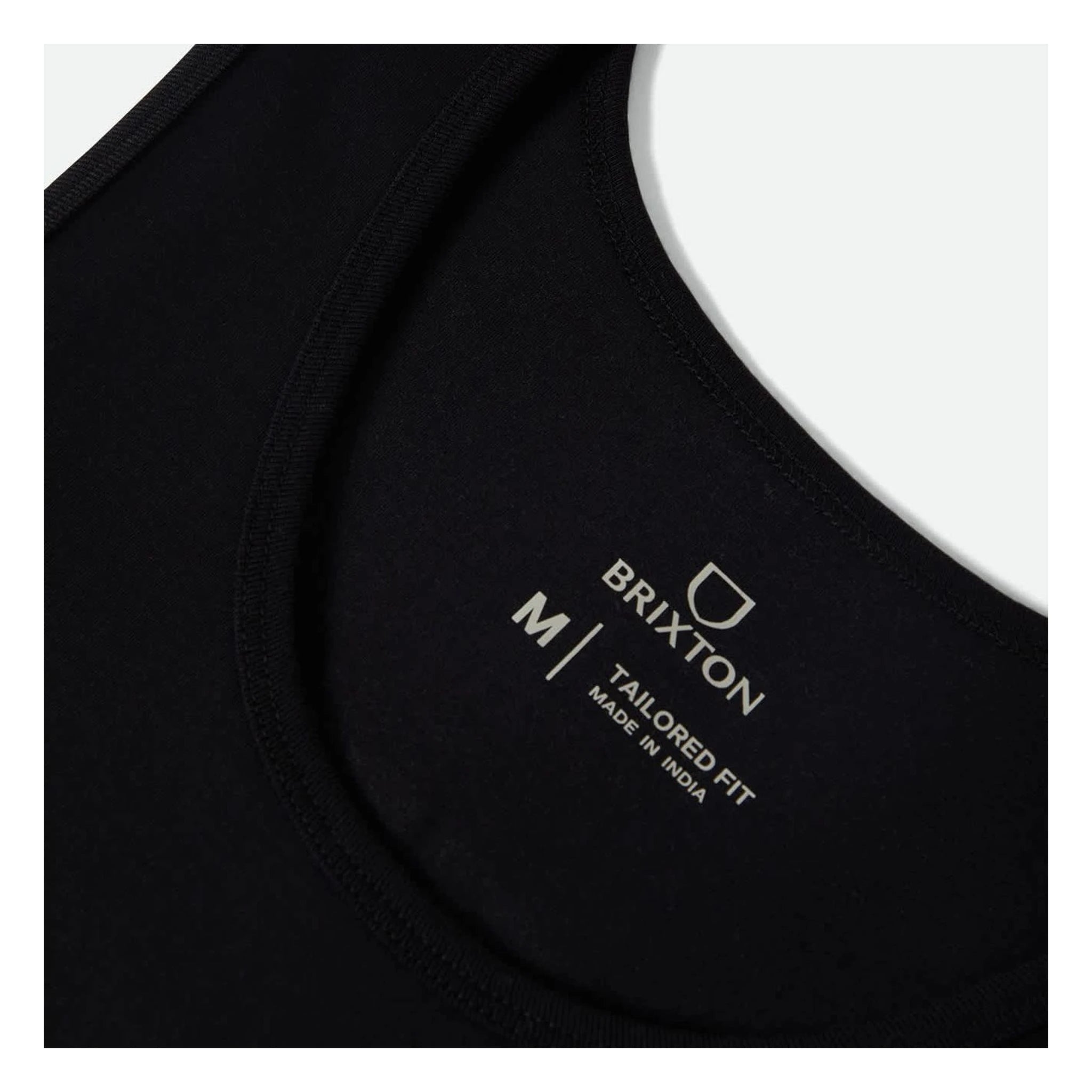 Care label on Rhett Tank Top Apparel Black Apparel showing Gray text on black fabric reading "BRIXTON M/TAILORED FIT MADE IN