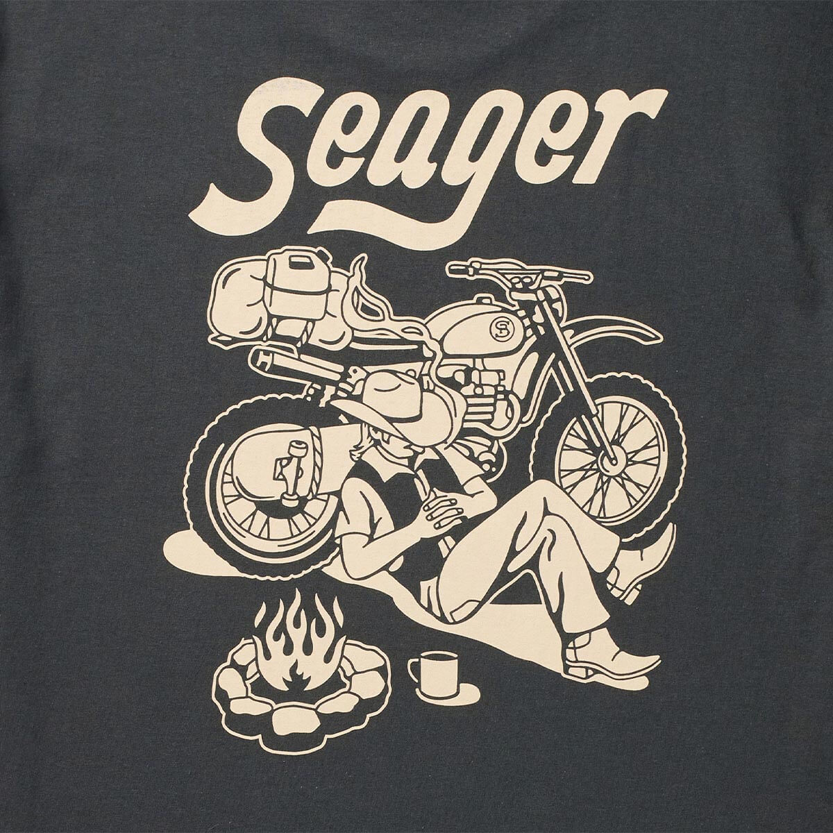 Close-up of Romero White Tee showing Cream print texture showing line-art motorcycle and campfire illustration on charcoal