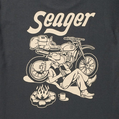 Close-up of Romero White Tee showing Cream print texture showing line-art motorcycle and campfire illustration on charcoal