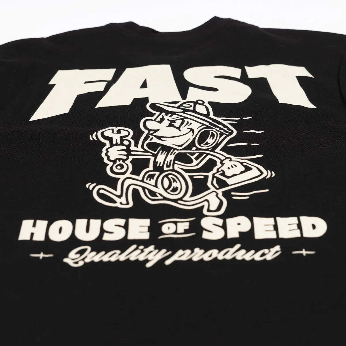 Close-up of Runner Black Tee showing Cream print texture showing bold sans-serif type and cartoon engine graphic with