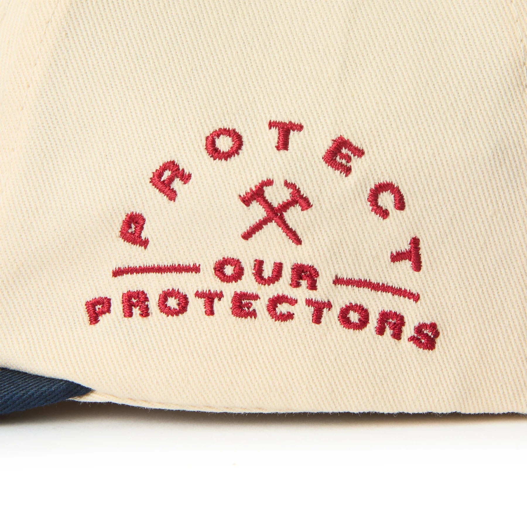 Care label on X Coors Banquet P.o.p. Snapback Cream/navy-cream/navy Hat showing Red embroidered text reading "Protect Your