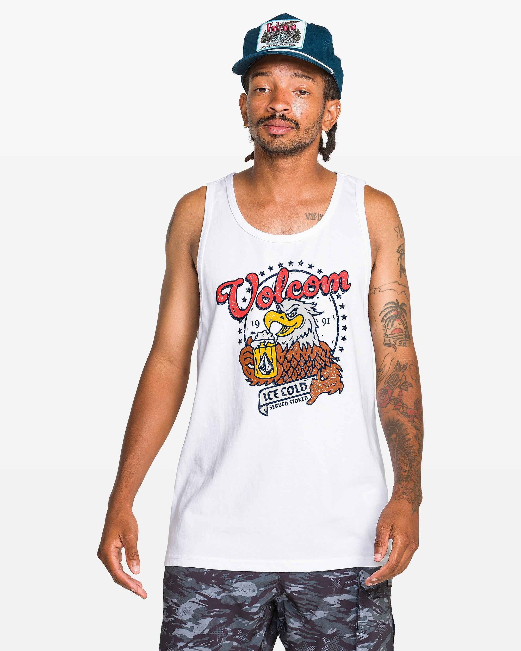 Person wearing Serve Stoked Tank Apparel White Apparel, Man wearing white tank top with eagle graphic in studio setting