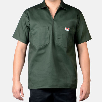 Person wearing Short Sleeve Solid Half Zip S/S Woven Black S/S Woven, Man wearing olive green short-sleeve work shirt