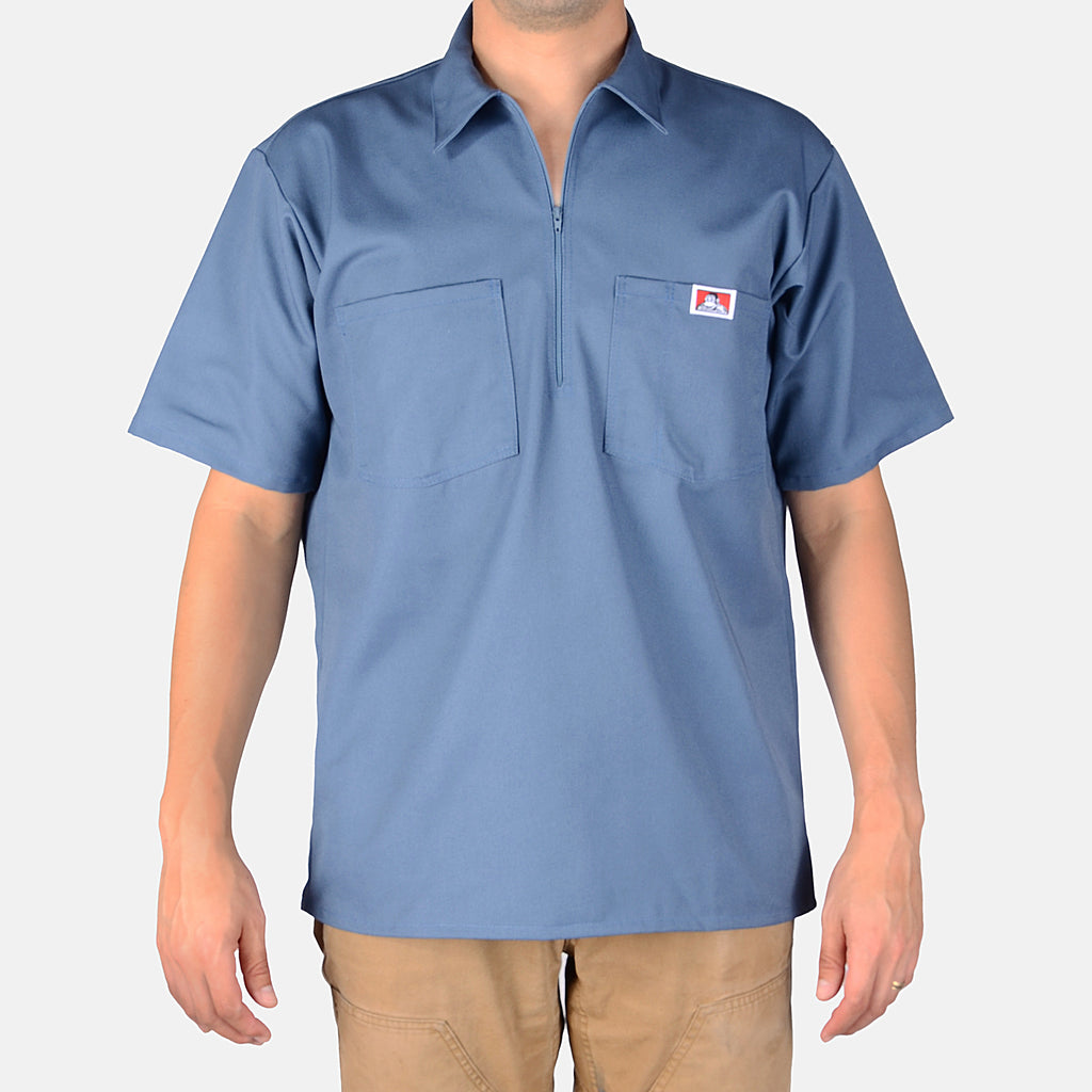 Person wearing Short Sleeve Solid Half Zip S/S Woven Black S/S Woven, Slate blue work shirt with half-zip front and dual