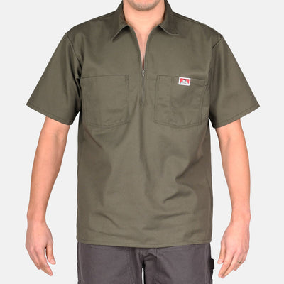 Person wearing Short Sleeve Solid Half Zip S/S Woven Black S/S Woven, Man wearing olive work shirt with two chest pockets