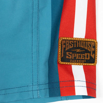Close-up of Skeg 19" Boardshort Apparel Indigo Apparel showing Woven label patch with gold embroidered border and text on