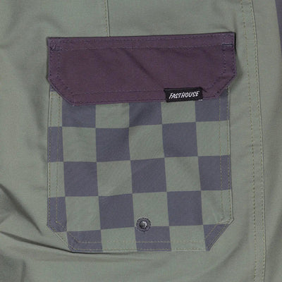 Close-up of Skeg 21" Boardshorts Apparel Olive Apparel showing Purple and cream checkerboard pocket with woven label and
