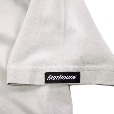 Close-up of Spanner Mirage Gray Tee showing Black woven label with white italic text on white cotton hem - Slowride Supply