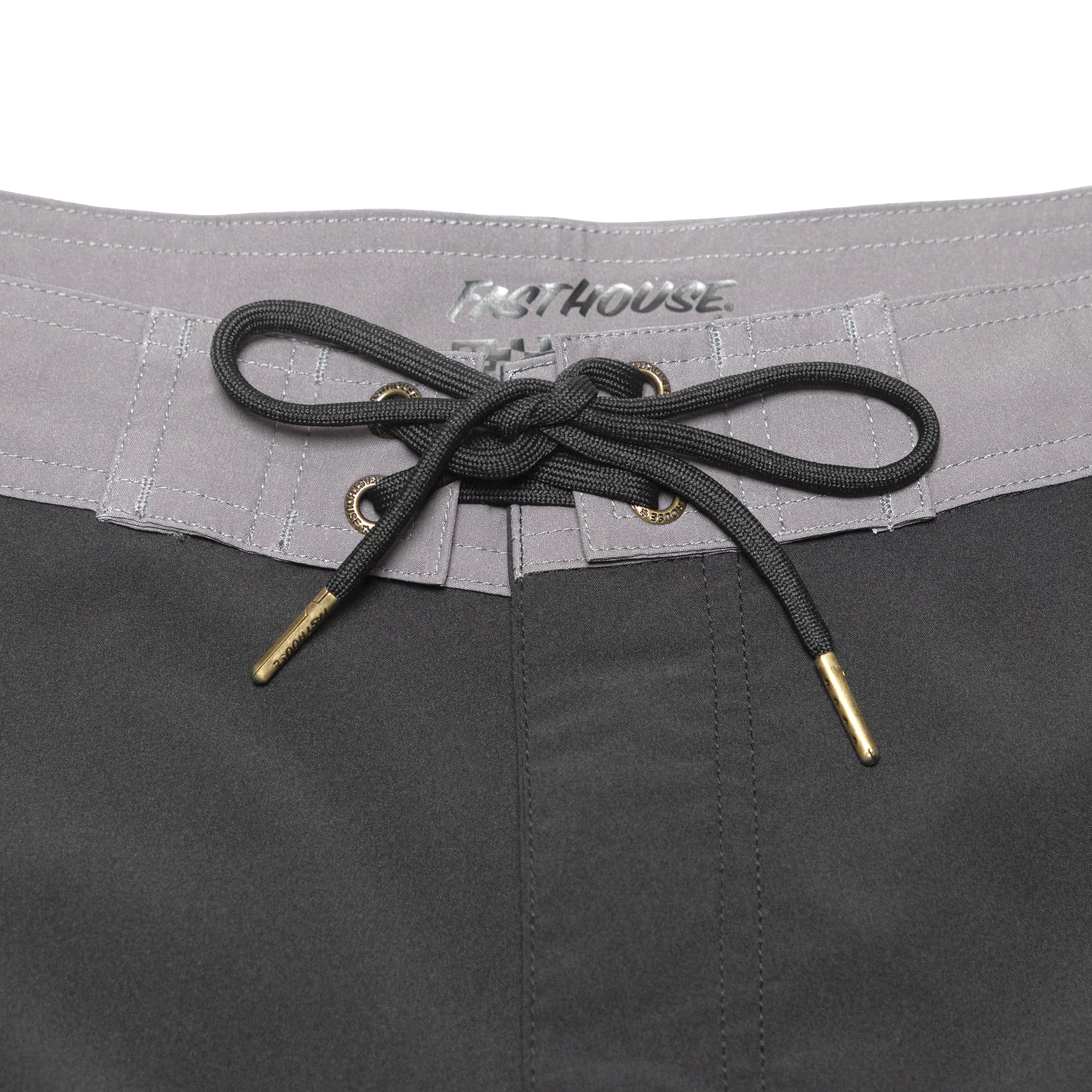 Close-up of Stealth 21" Boardshort Boardshorts Black Boardshorts showing Gray waistband with embroidered text and black