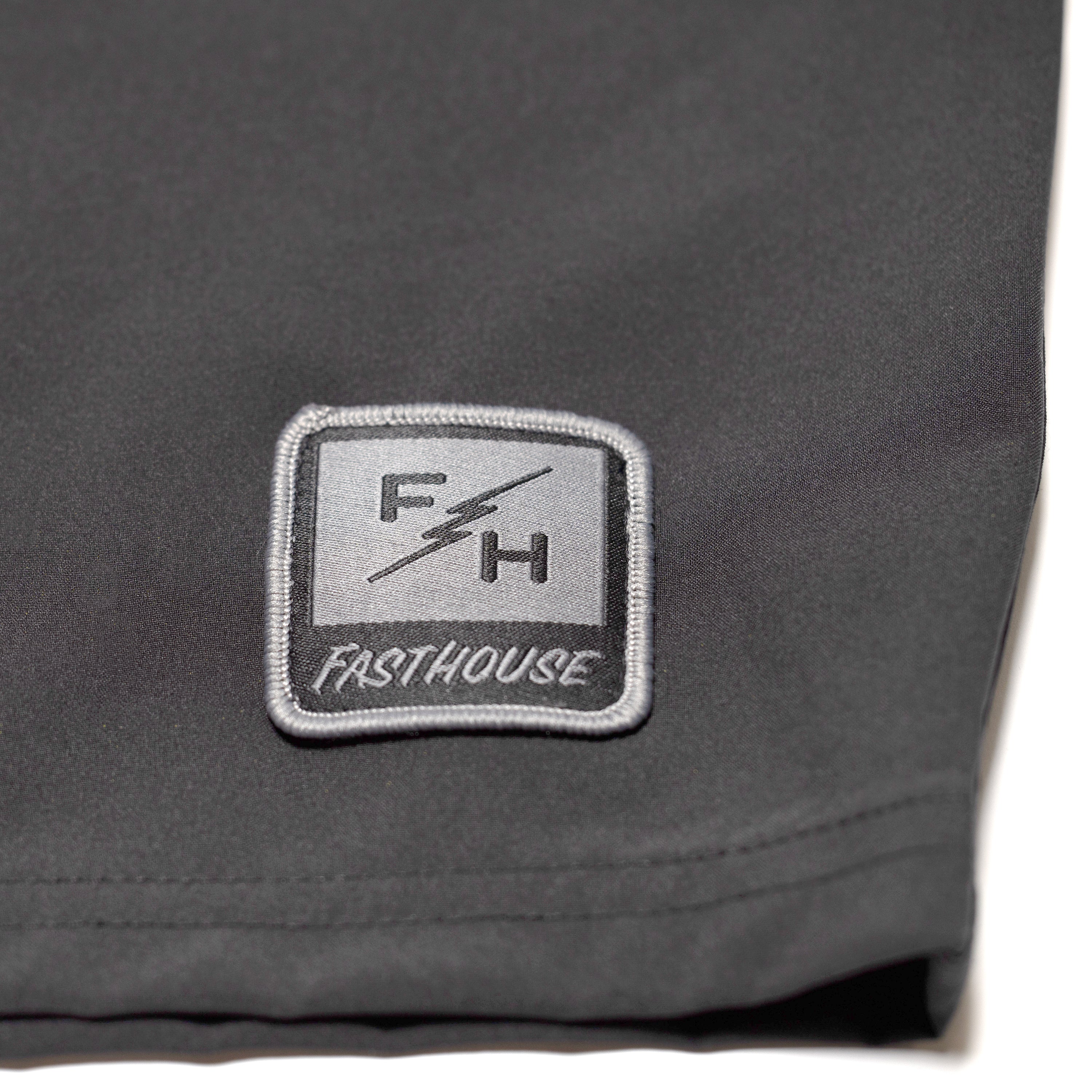 Close-up of Stealth 21" Boardshort Boardshorts Black Boardshorts showing Embroidered rectangular patch with FH lightning