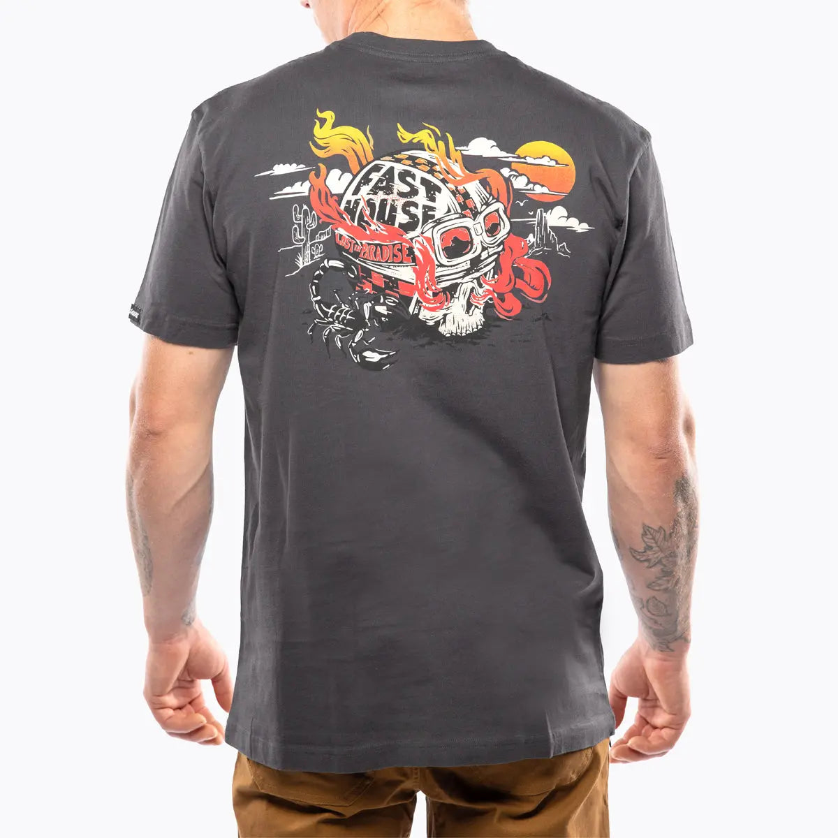 Person wearing Stinger Graphite Black Tee, Man wearing graphite black tee in desert setting with cacti and sun - Slowride
