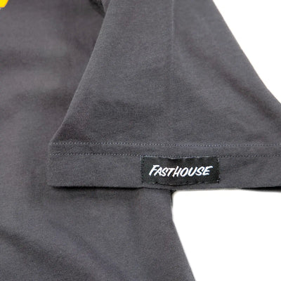 Close-up of Stinger Graphite Black Tee showing Black woven label with white text sewn into gray ribbed fabric seam -