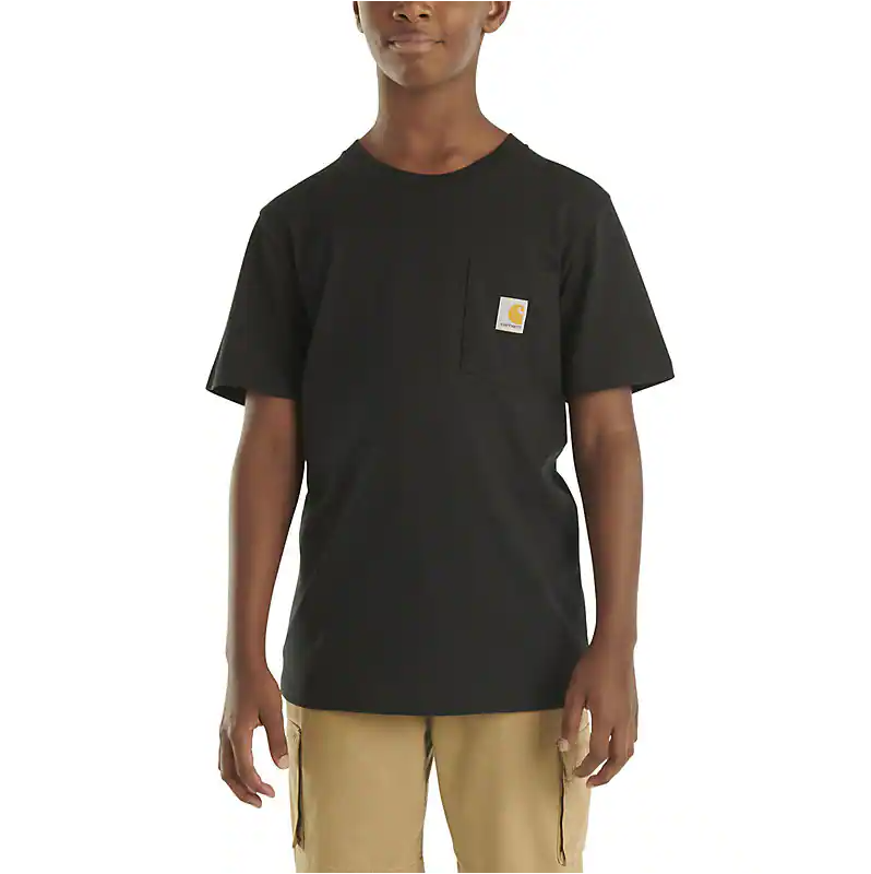 Person wearing Tk6513 Short Sleeve Pocket Tee Kids Brown Kids Tee, Boy wearing black tee with small chest patch standing