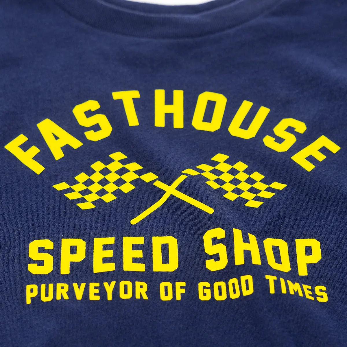 Close-up of Toddler Crossroads Tee Navy Kids Navy Kids Tee showing Yellow printed graphic showing checkered flags and