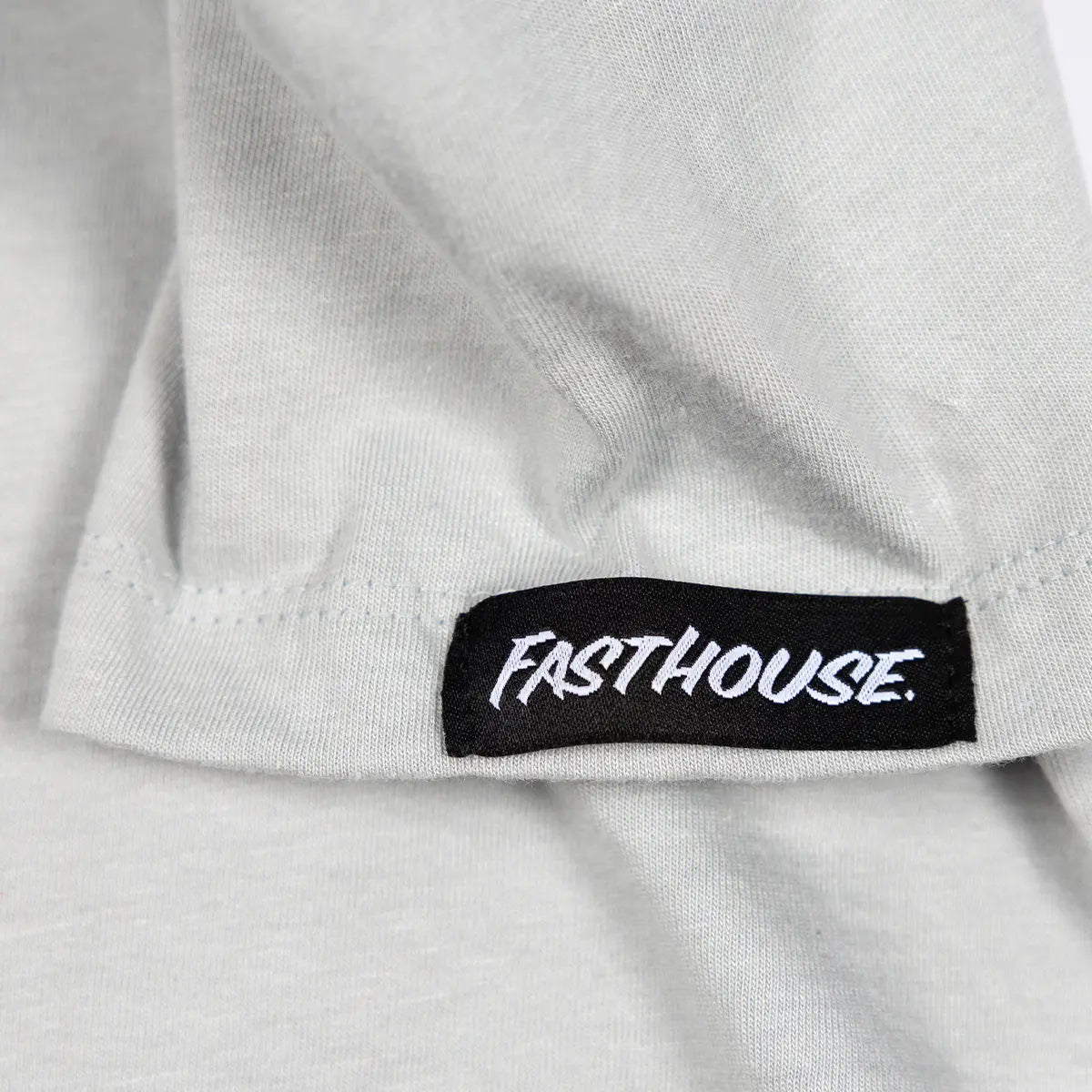 Close-up of Toddler Emblem Solid Athletic Gray Tee showing Black woven label with white italic type on white cotton hem -