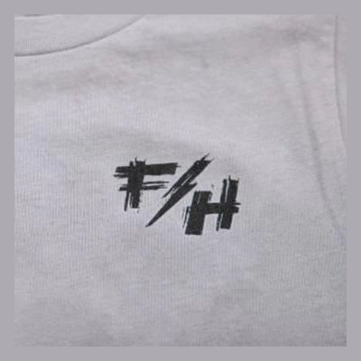 Close-up of Toddler Fray Tee Kids Light Gray Kids Tee showing Black hand-drawn graphic print with abstract angular marks and