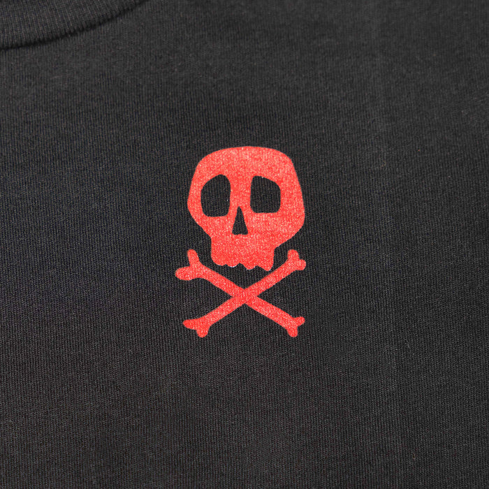 Close-up of Toddler Lost Boys Tee Kids Black Kids Tee showing Red skull and crossbones print on black ribbed cotton fabric -