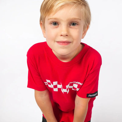 Person wearing Toddler Riff Tee Kids Red Kids Tee, Child posed against plain white backdrop wearing red tee - Slowride Supply