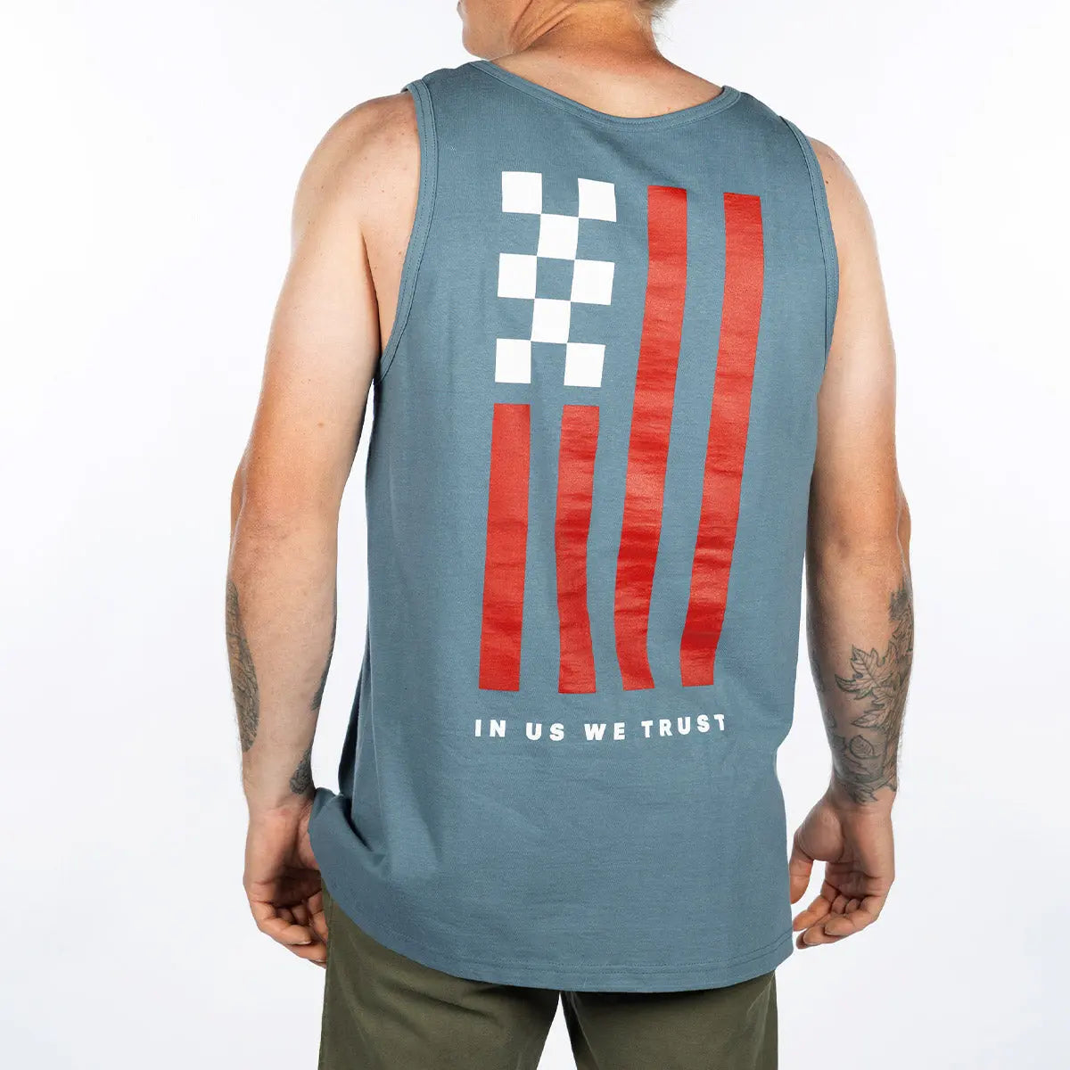 Person wearing Trust Tank Apparel Indigo Apparel, Man wearing tank top against plain white background, posed from behind