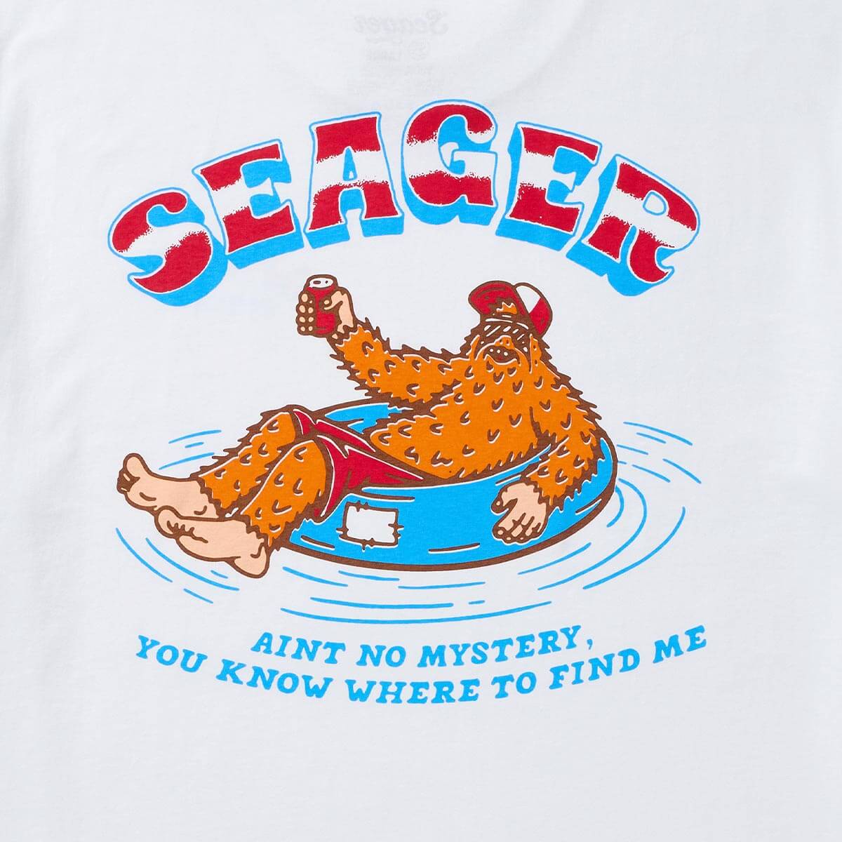 Close-up of Tubular White Tee showing White with red and blue distressed block lettering, orange furry character in blue