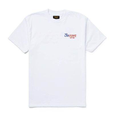 Close-up of USA Russ Vintage Black Tee showing White tee with small embroidered script logo in blue and red on chest -